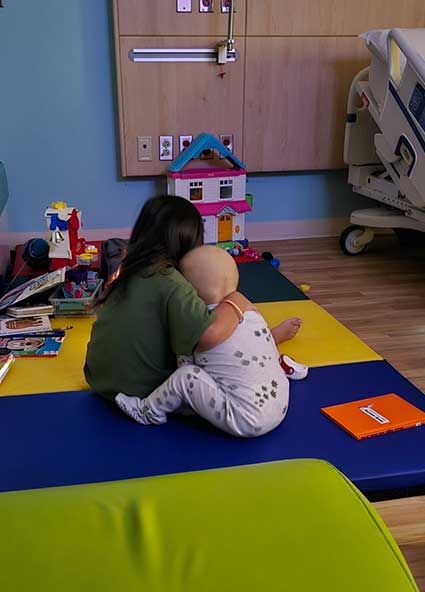 Ciro and his brother hugging while playing at CHRISTUS Children's