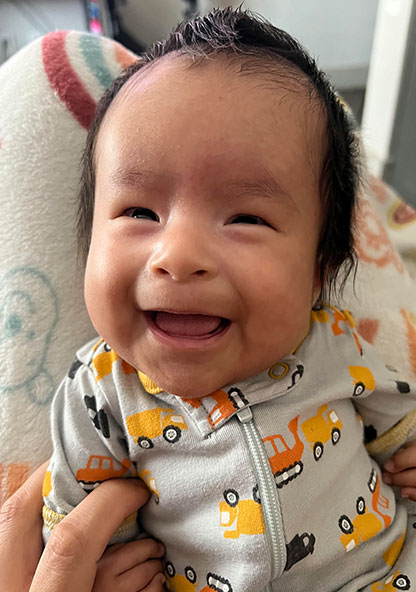 John Mendez, Jr. smiling at home after leaving CHRISTUS Children's