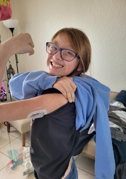 Mia smiling with her insulin pump