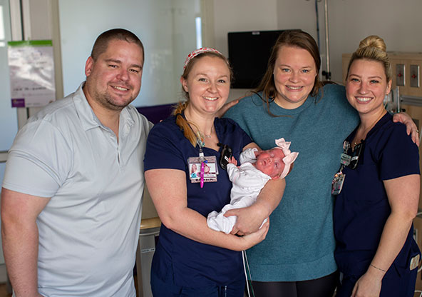 The Speckmans and two female NICU nurses are holding Lily and smiling for the picture. Lily spent 101 days in the NICU. 