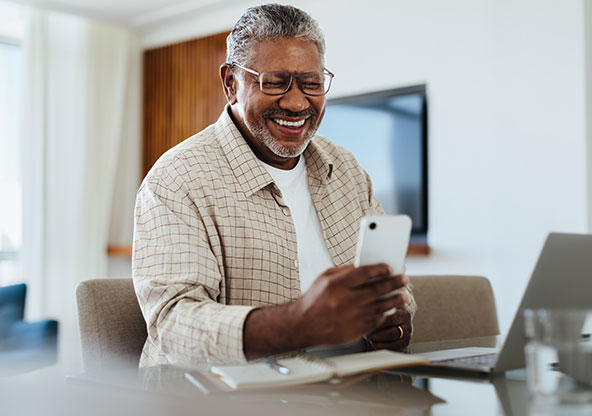 Happy man using MyCHRISTUS to get medical care. 