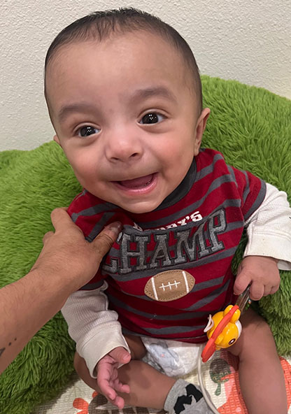 Baby Xavian is smiling at the camera after being released from the hospital after 6 months