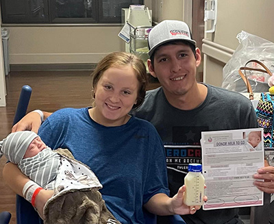 Mom, dad and newborn son with donor milk