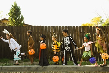 Little kids in costume trick or treating