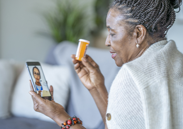Senior African American woman speaking with her general practitioner via video call during the COVID-19 pandemic to avoid an in person appointment.