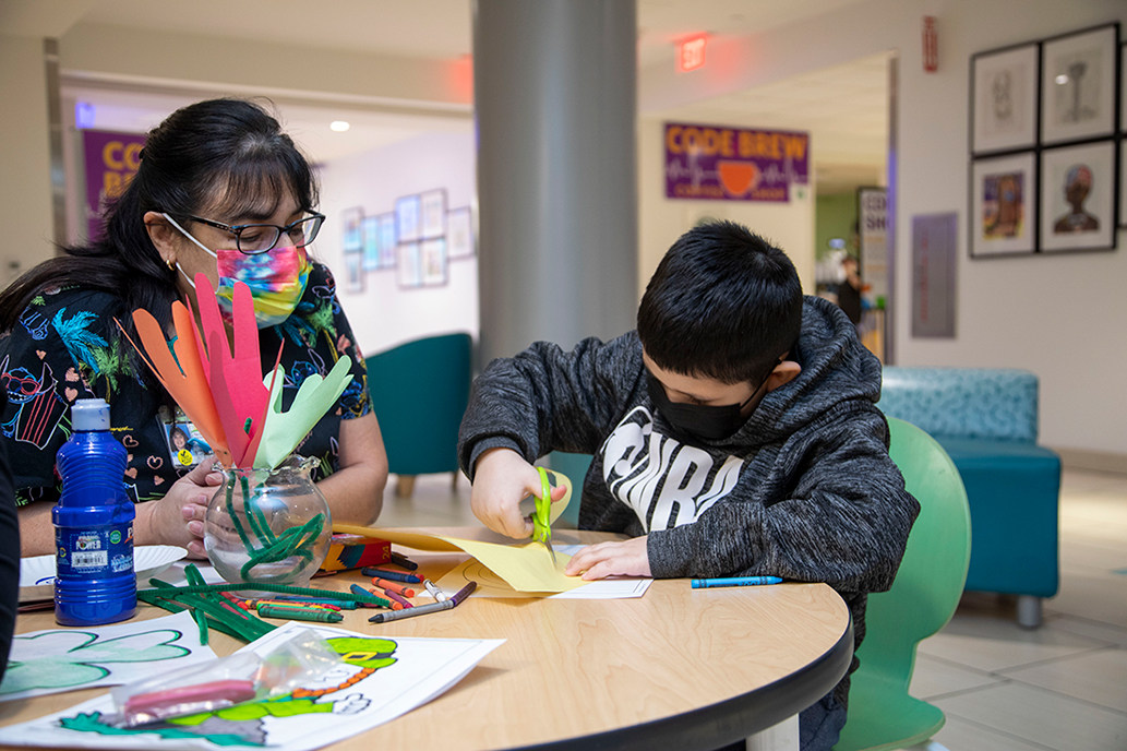 Child Life Specialist works with a patient through art therapy